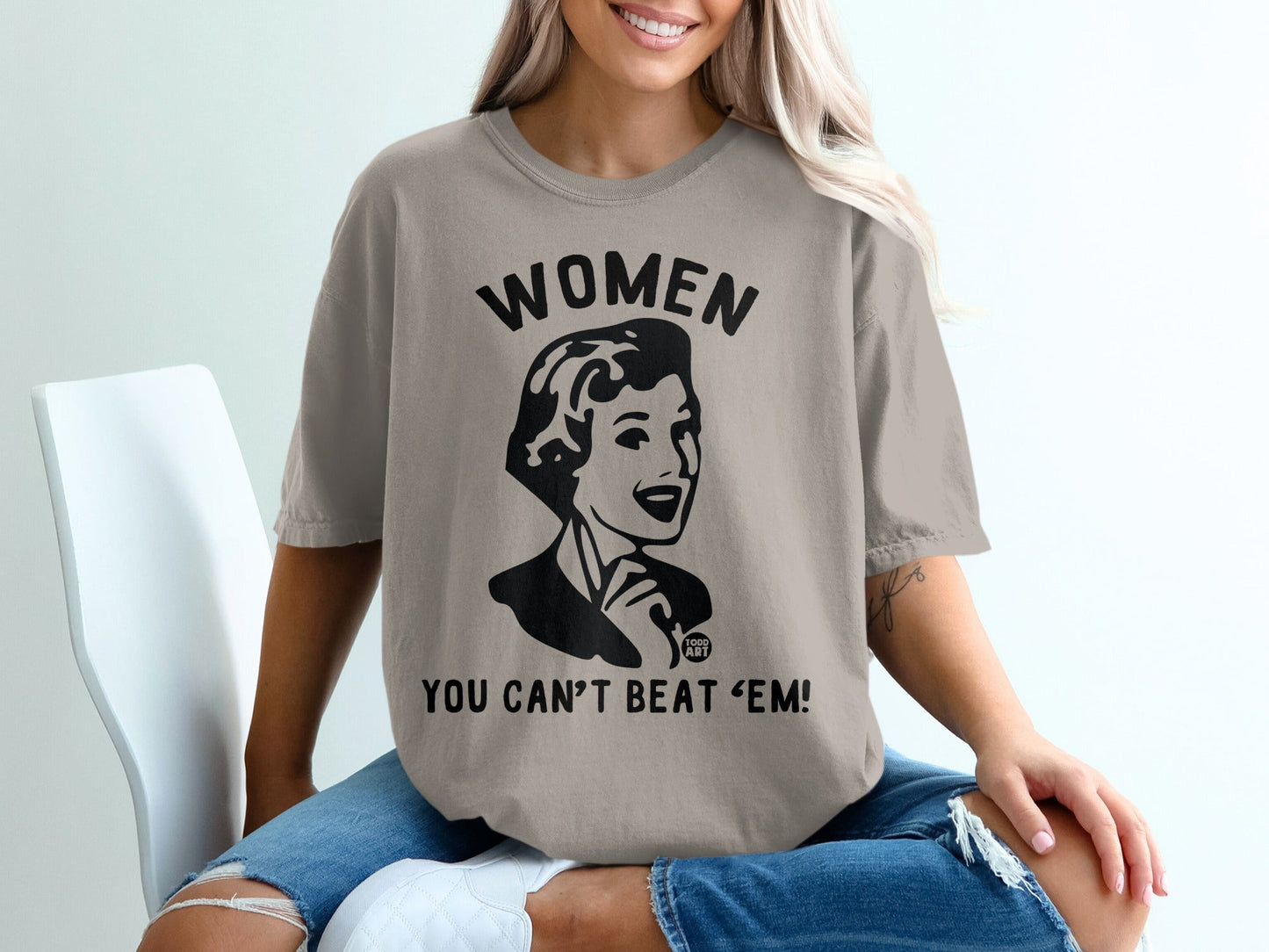 T-shirt with black graphic: "WOMEN YOU CAN'T BEAT 'EM!"