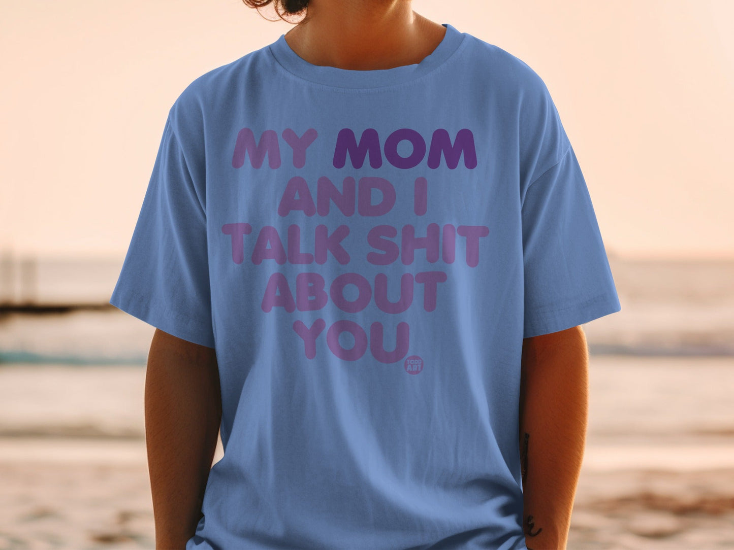 Purple text on a blue t-shirt reads "MY MOM AND I TALK SHIT ABOUT YOU".