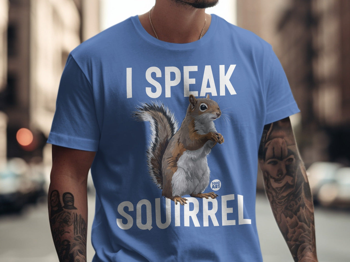 Blue t-shirt with "I SPEAK SQUIRREL" text and squirrel graphic.
