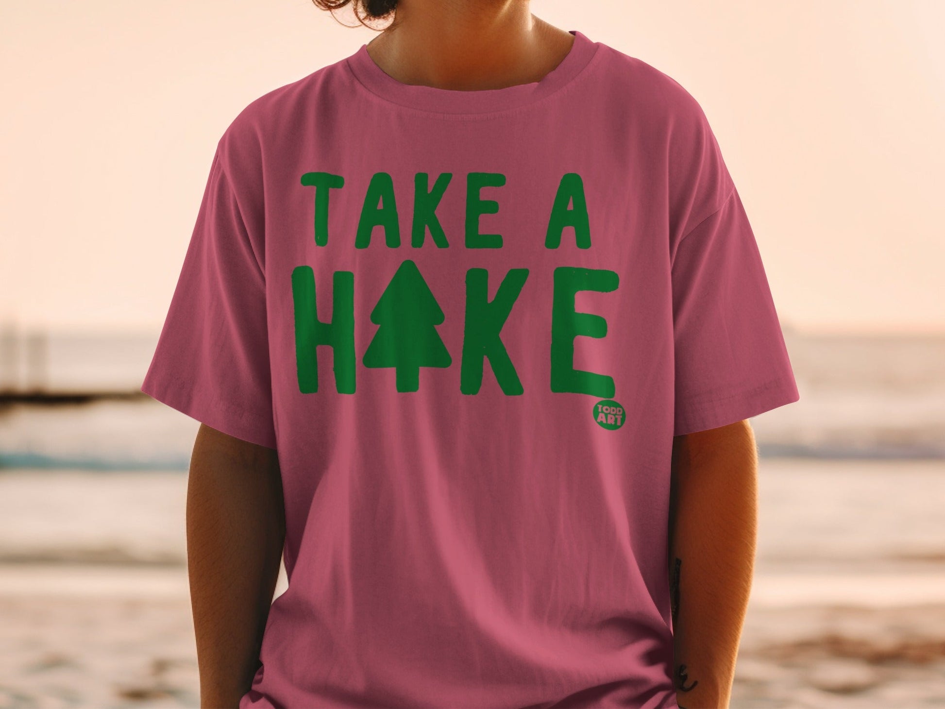 Pink t-shirt with "TAKE A HAKE" and a Christmas tree graphic.