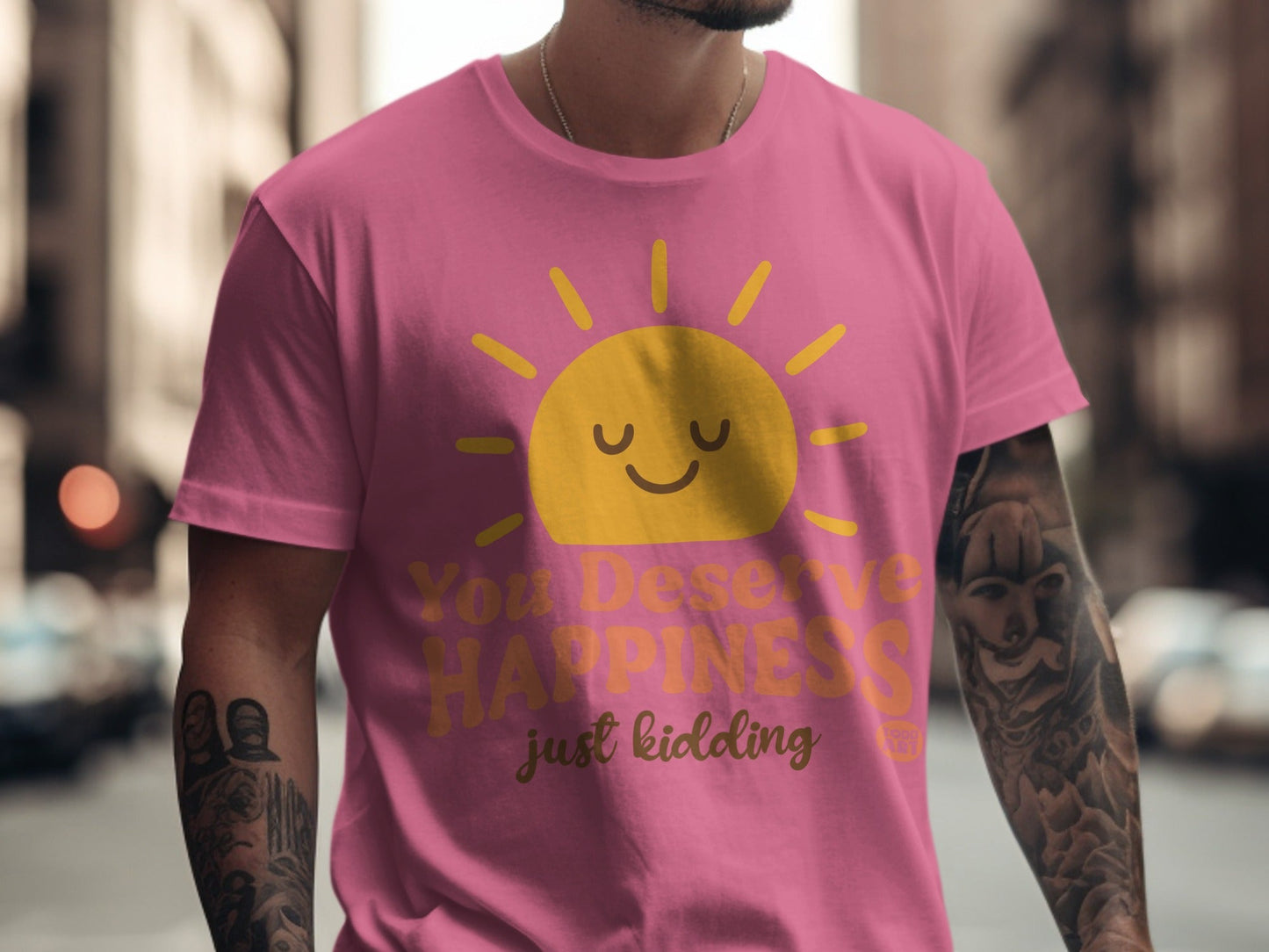Pink t-shirt with a smiling sun and "You Deserve Happiness just kidding" text.