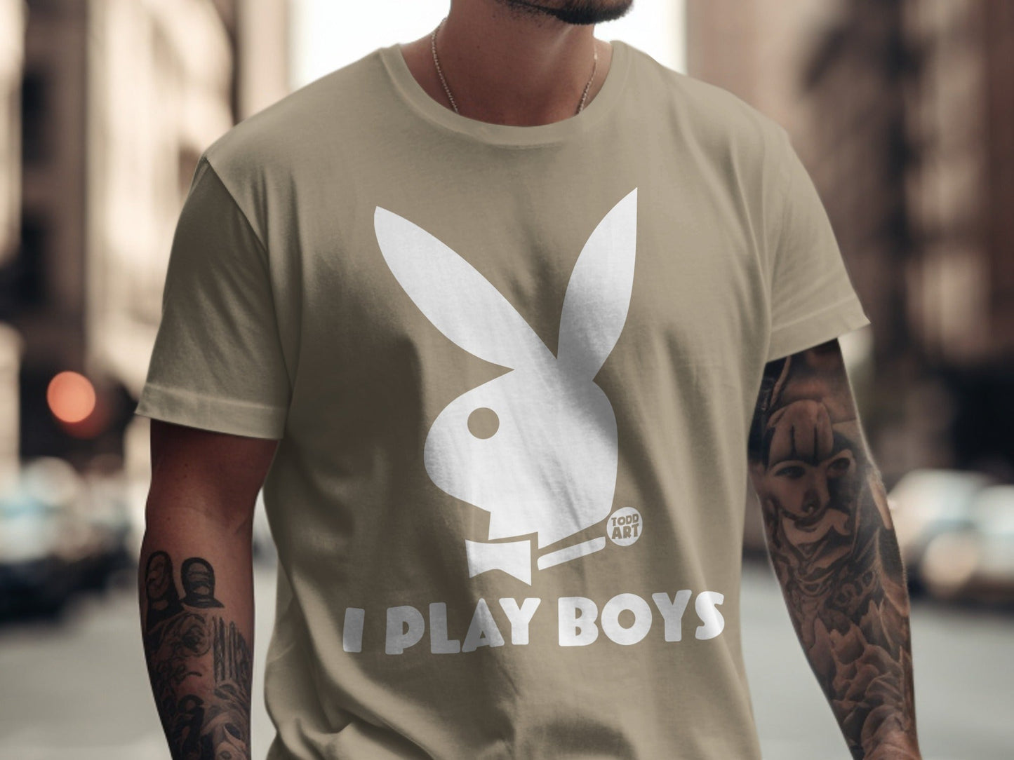 Tan t-shirt with white Playboy bunny logo and "I PLAY BOYS" text.