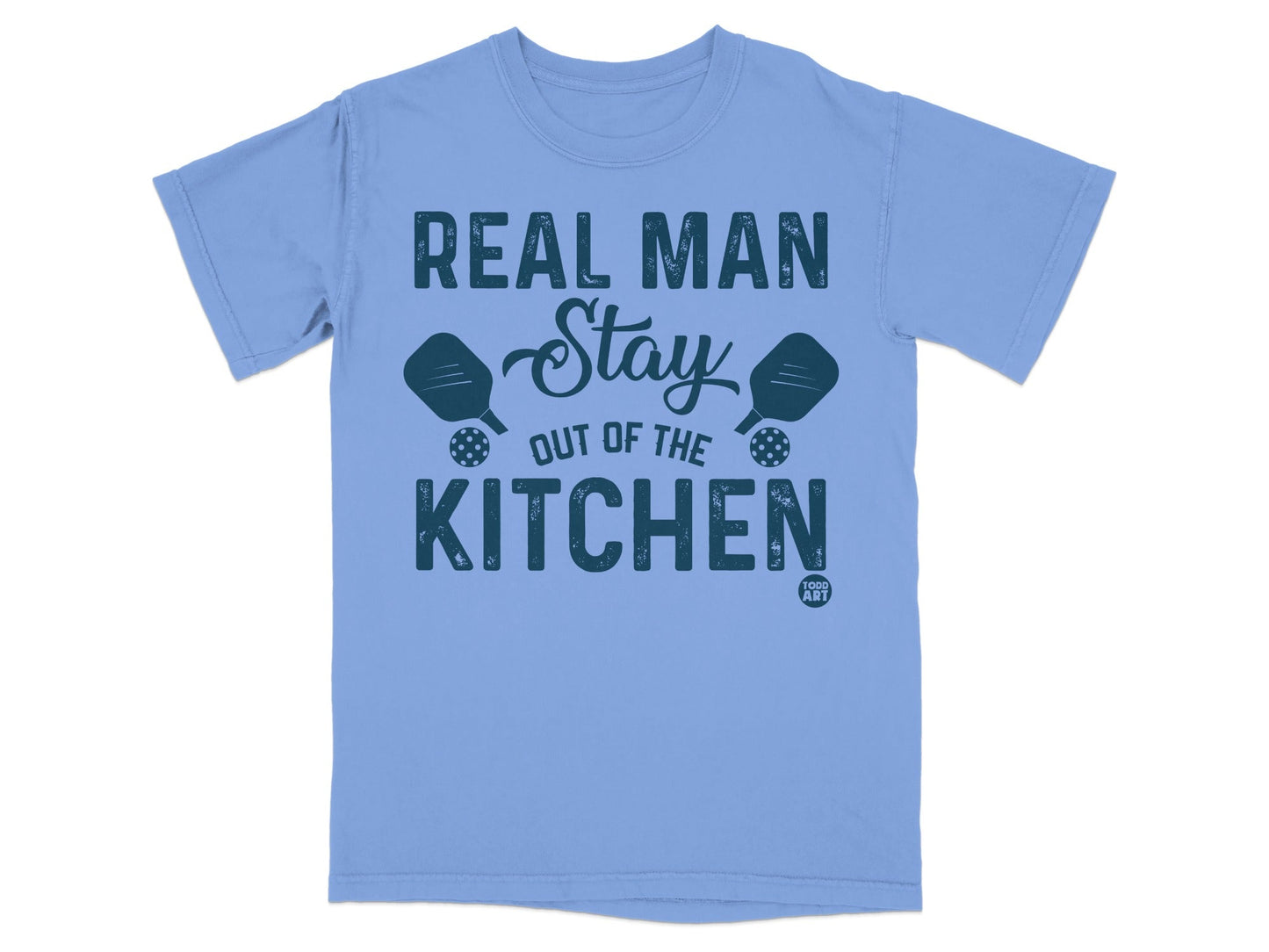 Light blue t-shirt with "Real Man Stay Out of the Kitchen" and pickleball paddles.