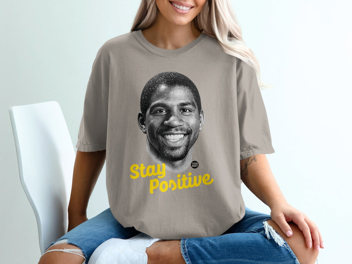 T-shirt with Magic Johnson's portrait and "Stay Positive" text.