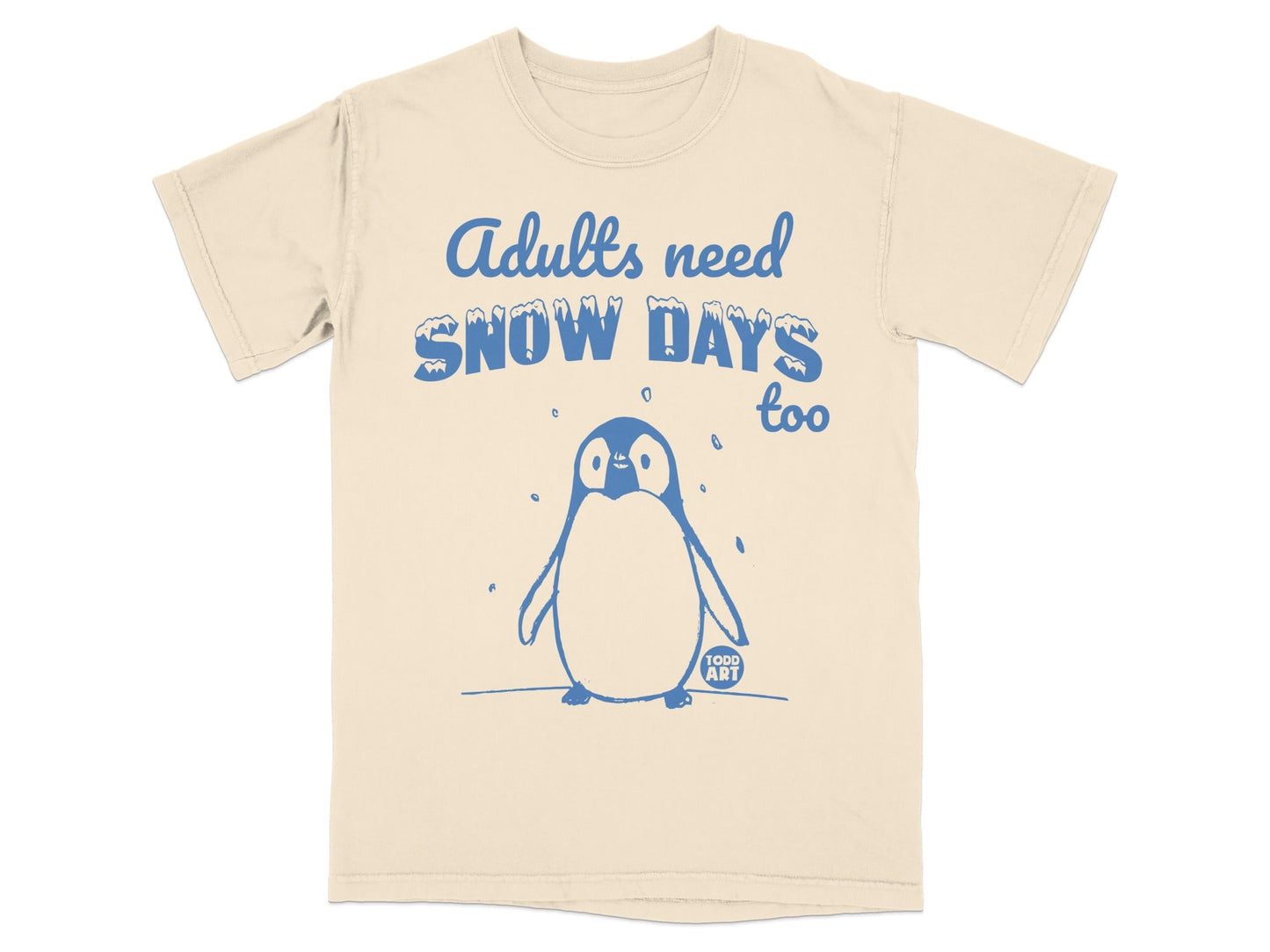 Beige t-shirt with cartoon penguin and text "Adults need snow days too".