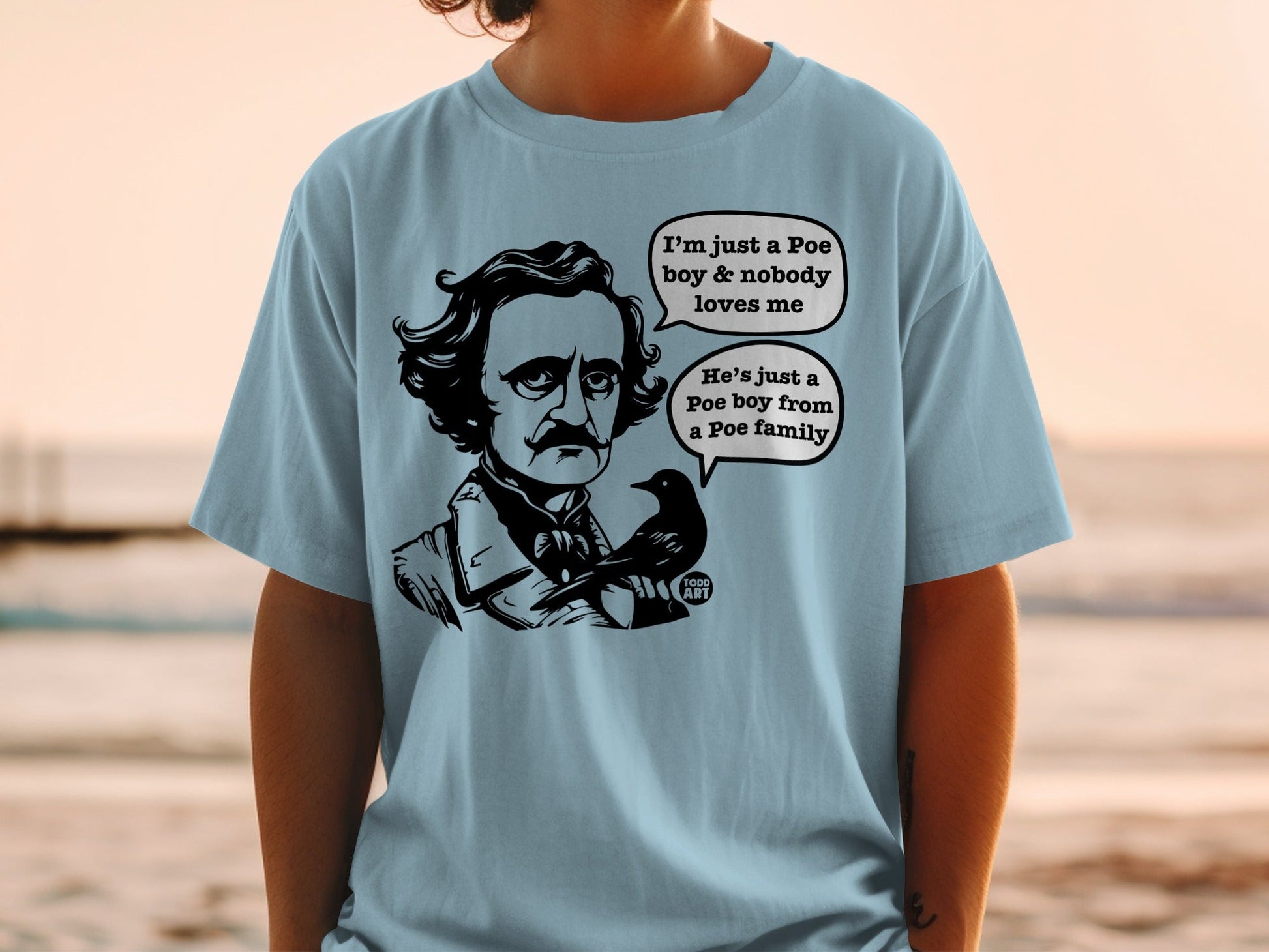 Light blue t-shirt with Edgar Allan Poe and a raven, text about a Poe boy.