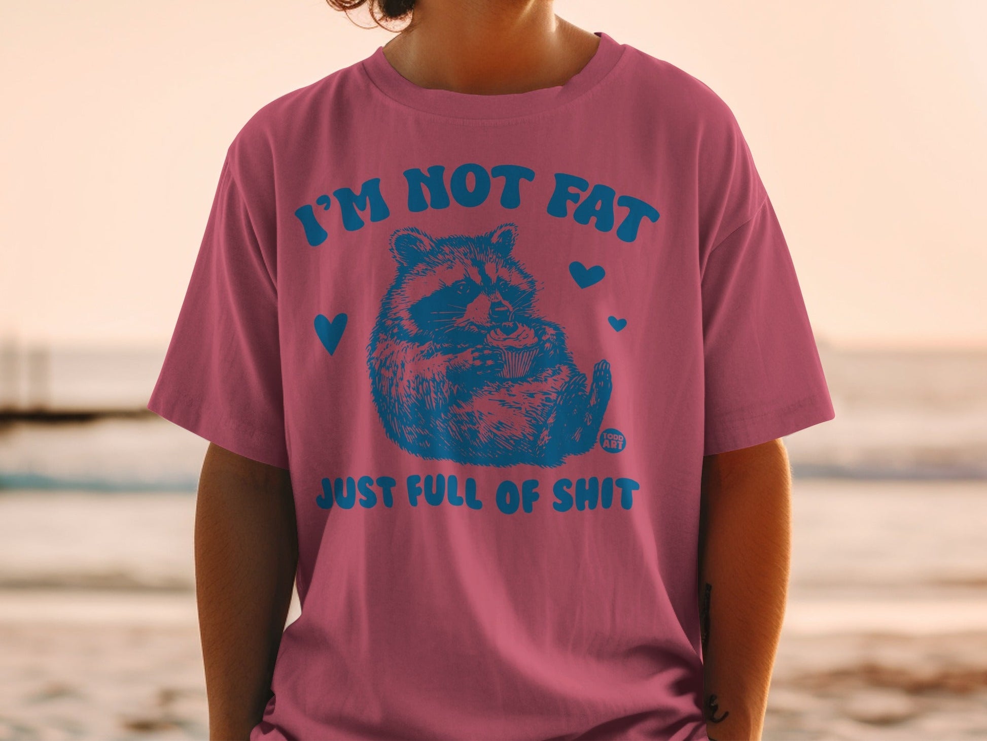 T-shirt with raccoon graphic and text "I'M NOT FAT JUST FULL OF SHIT".
