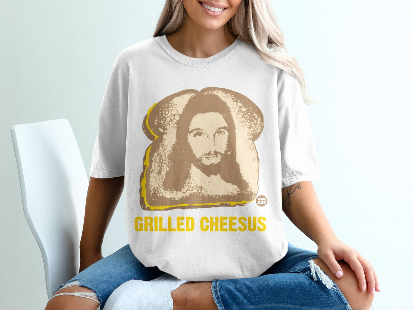 White t-shirt with "GRILLED CHEESUS" text and Jesus image in toast.