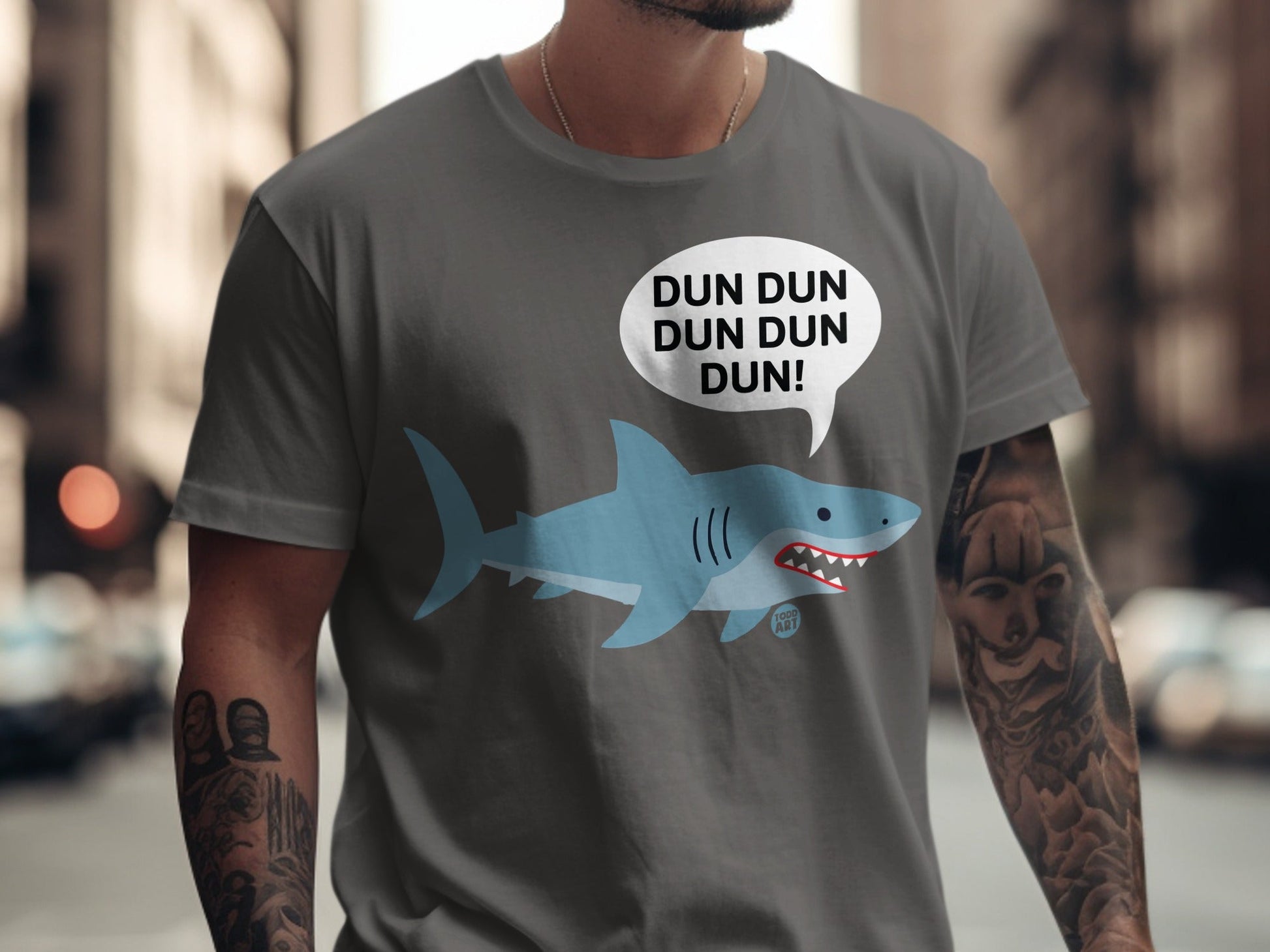 Grey t-shirt with a cartoon shark and "DUN DUN DUN DUN!" speech bubble.