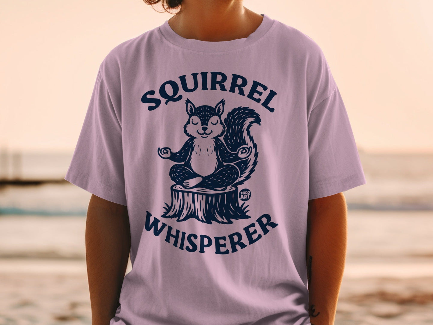 T-shirt with a meditating squirrel and the text "Squirrel Whisperer".