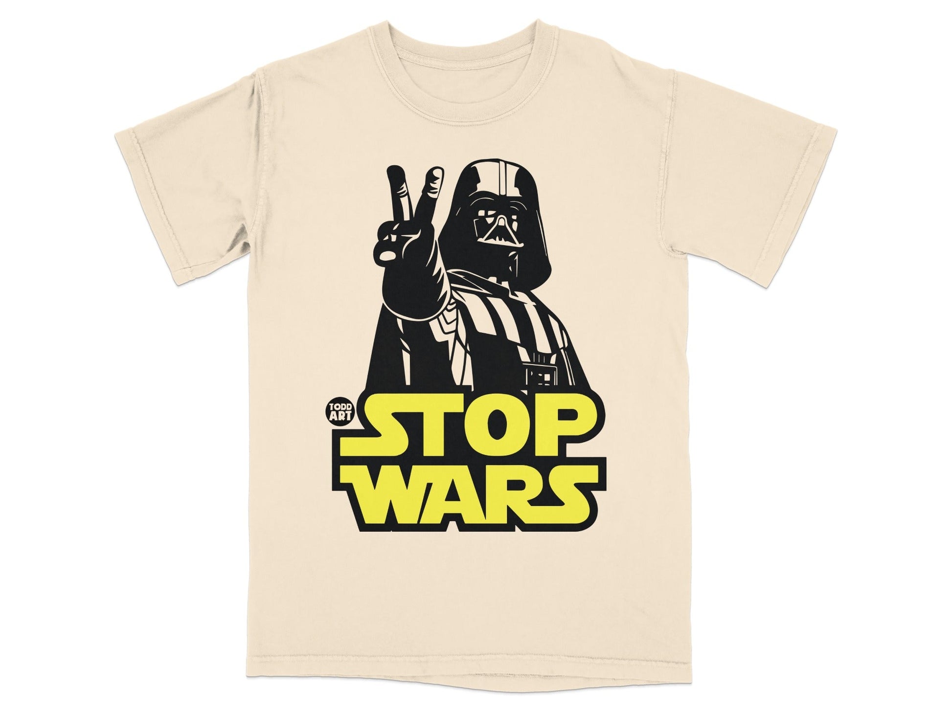 Darth Vader giving peace sign above "Stop Wars" text on a cream t-shirt.