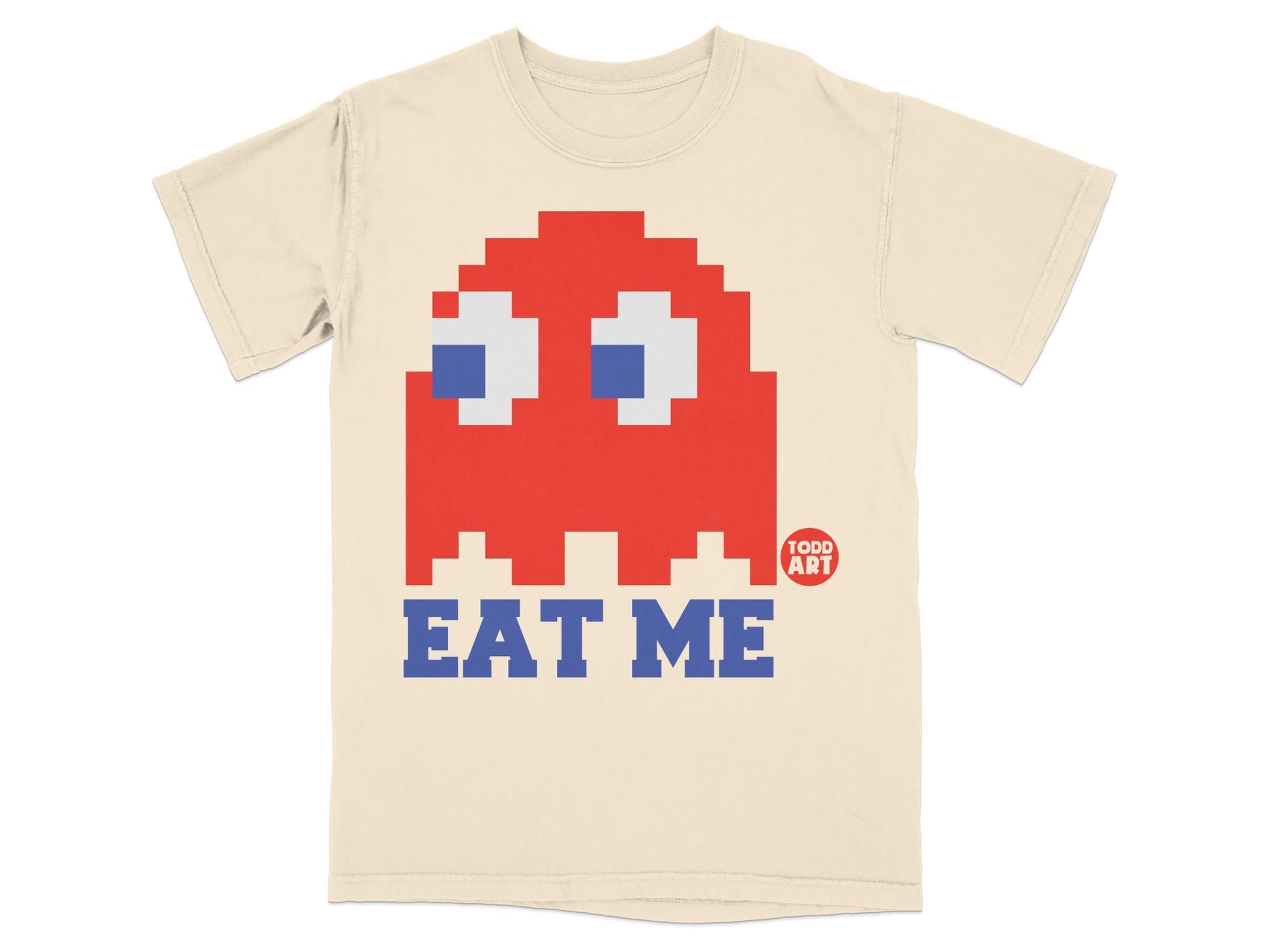 Cream t-shirt with red Pac-Man ghost and "EAT ME" text.