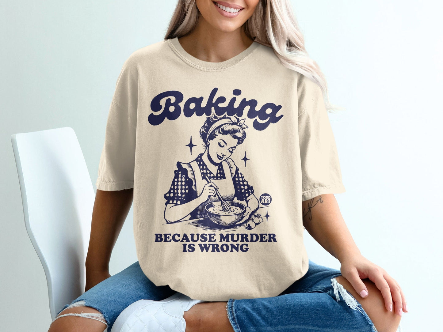 T-shirt with "Baking Because Murder Is Wrong" text and retro baking graphic.