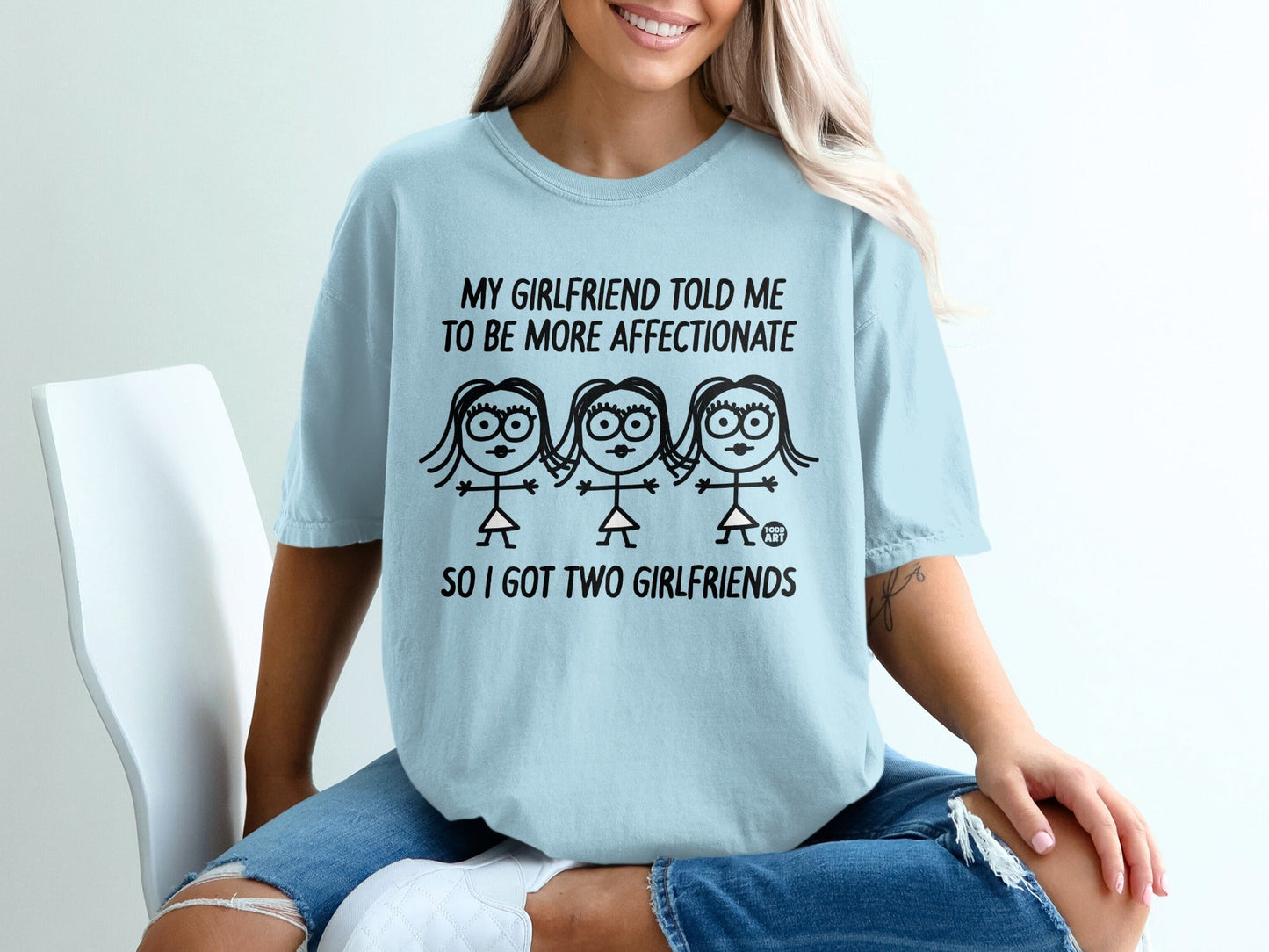 Light blue t-shirt with text "My girlfriend told me to be more affectionate so I got two girlfriends".