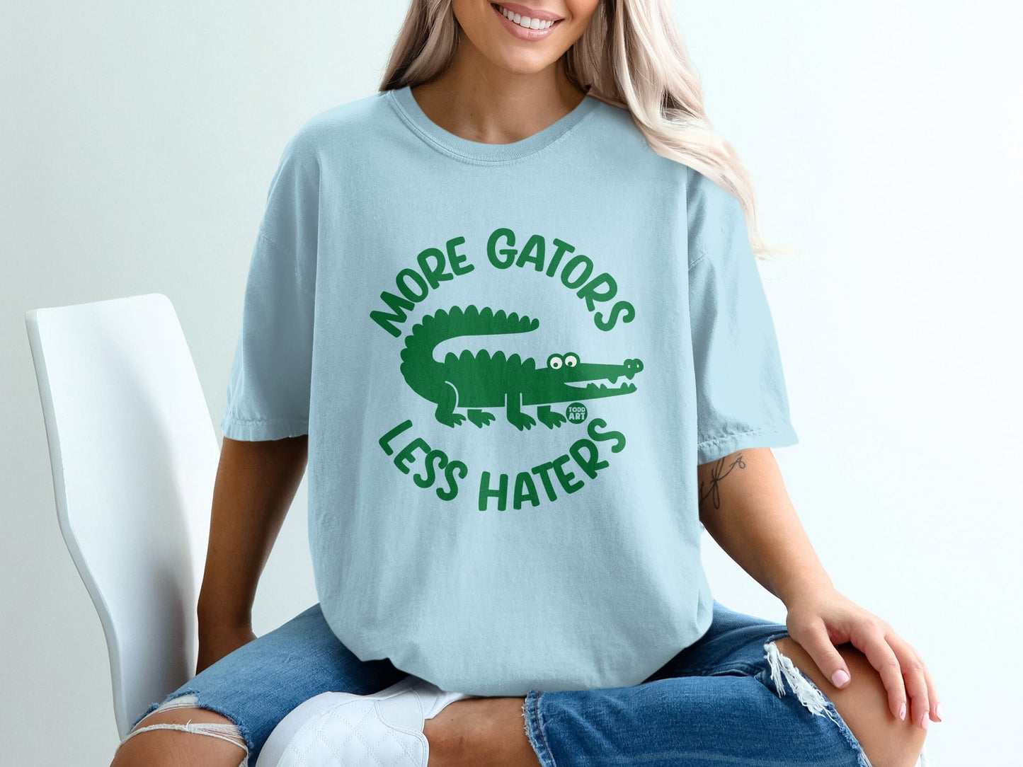 Light blue t-shirt with green text and alligator graphic, "MORE GATORS LESS HATERS".