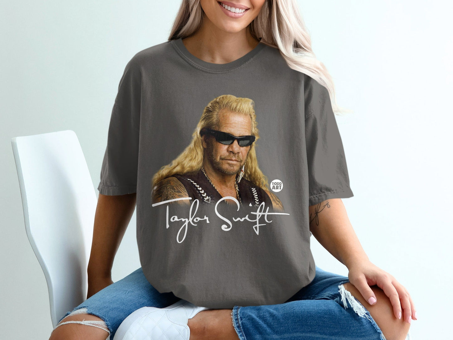 Dog the Bounty Hunter graphic on a gray t-shirt with "Taylor Swift" text.