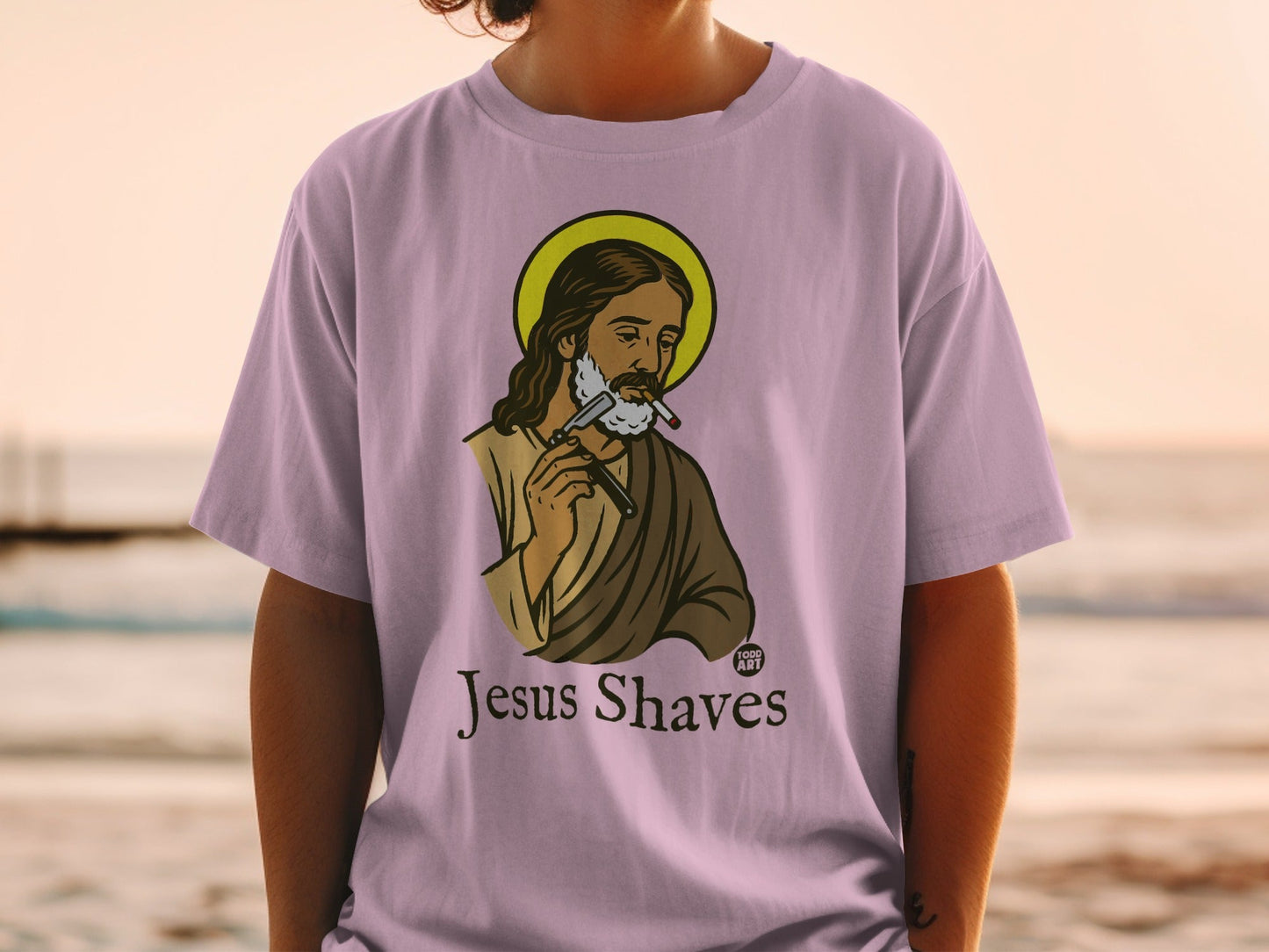 Jesus shaving his beard with a straight razor, text "Jesus Shaves".