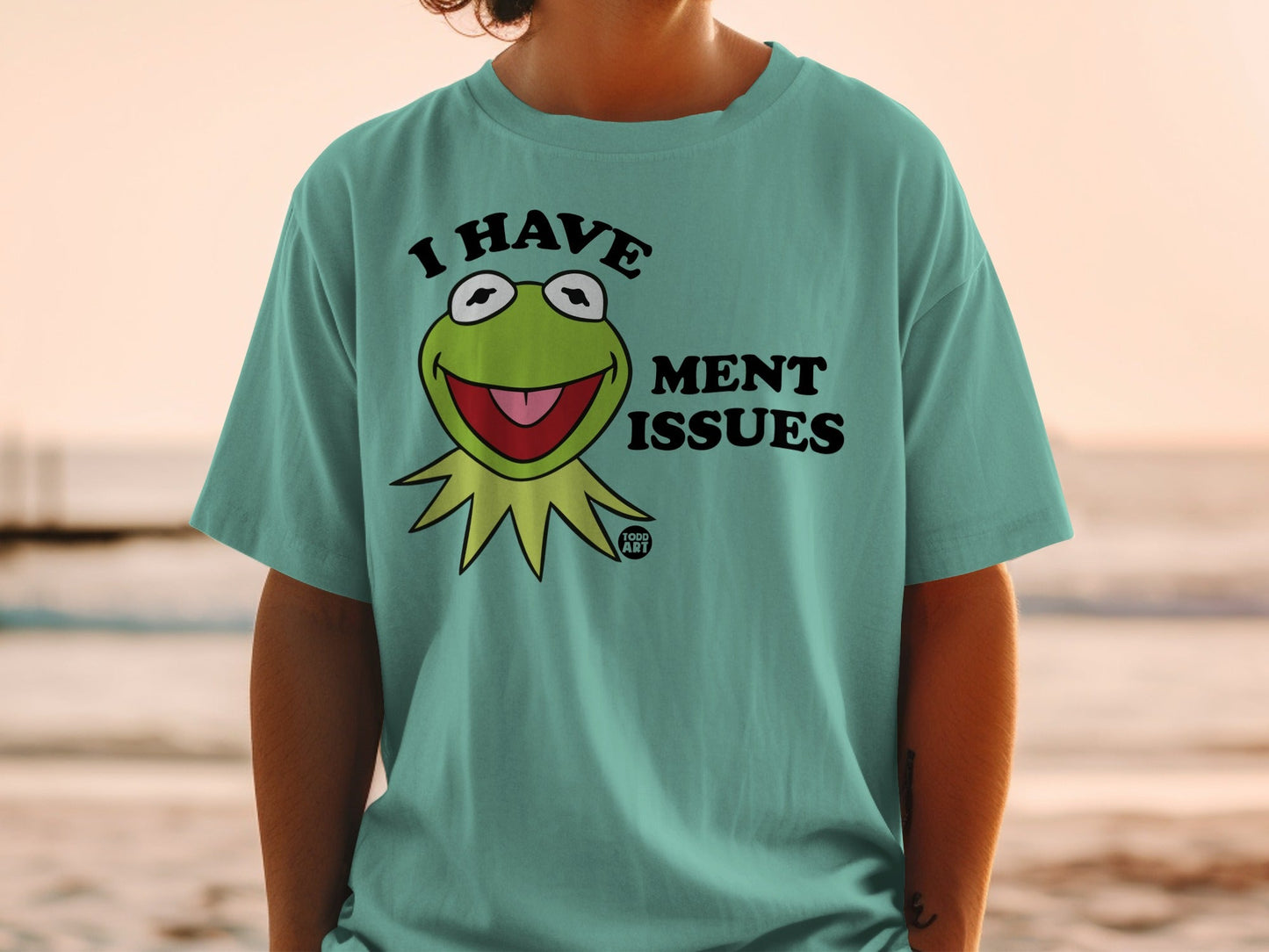 Kermit the Frog with "I Have Ment Issues" text on a teal t-shirt.