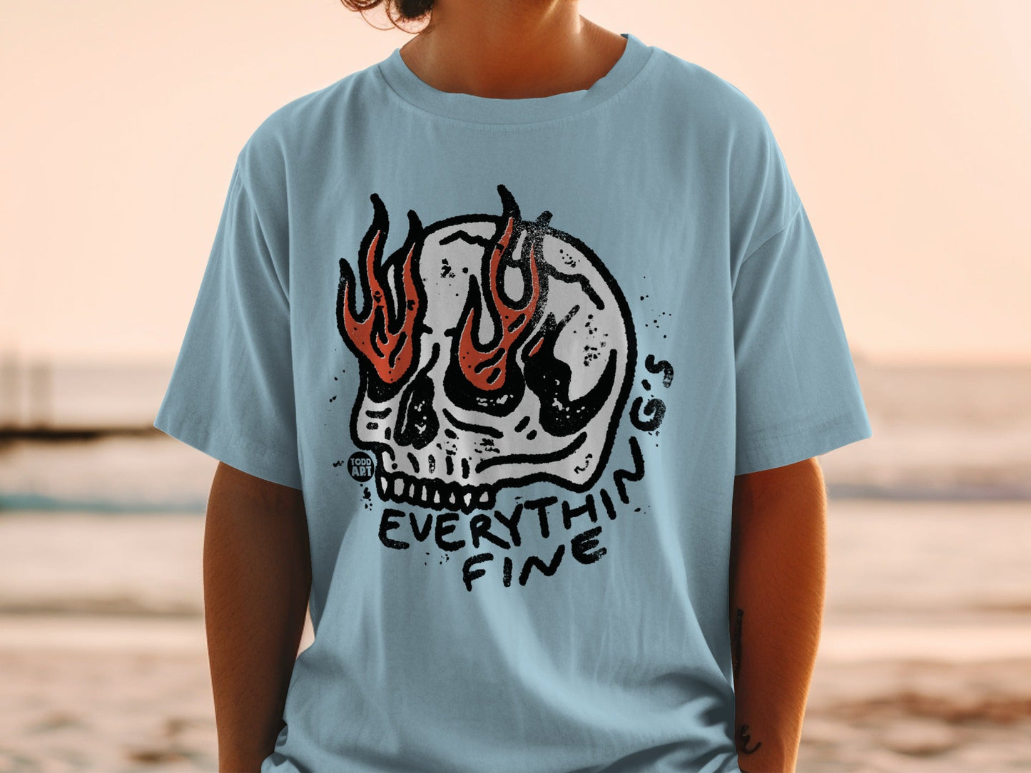 Light blue t-shirt with a flaming skull graphic and "EVERYTHING FINE" text.