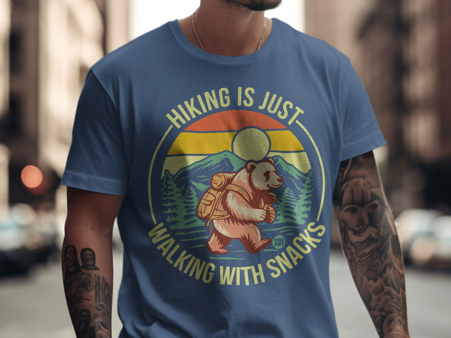 Bear wearing backpack on shirt with text "Hiking is just walking with snacks".