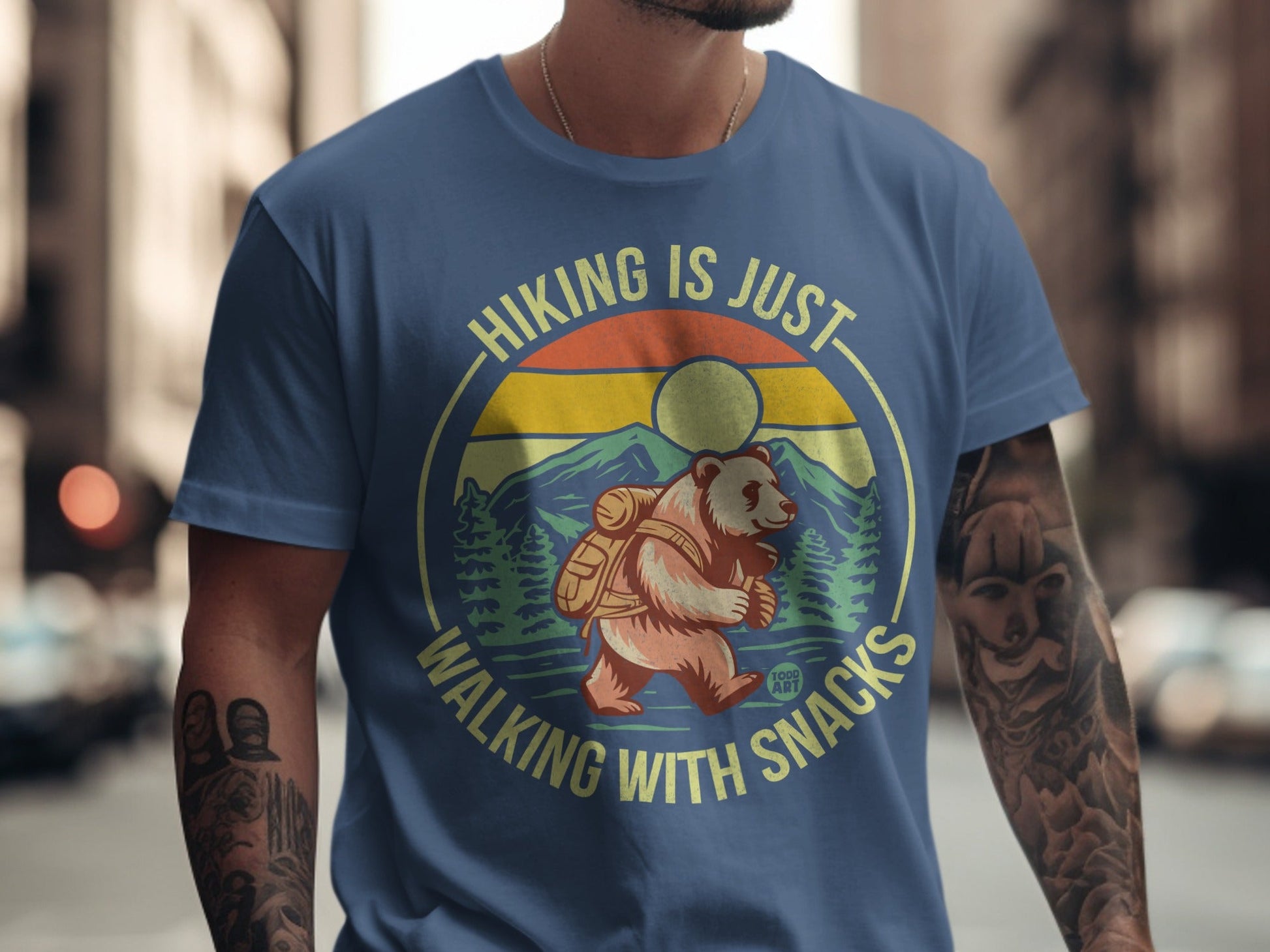 Bear wearing backpack on shirt with text "Hiking is just walking with snacks".