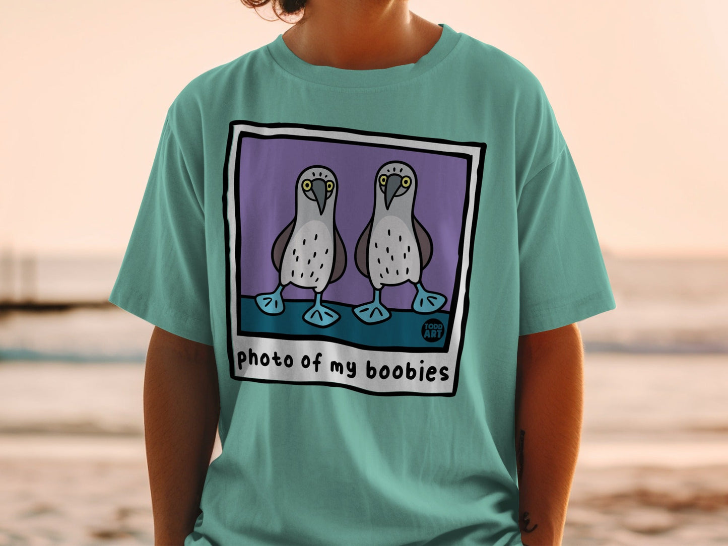 Teal t-shirt with cartoon blue-footed boobies and "photo of my boobies" text.