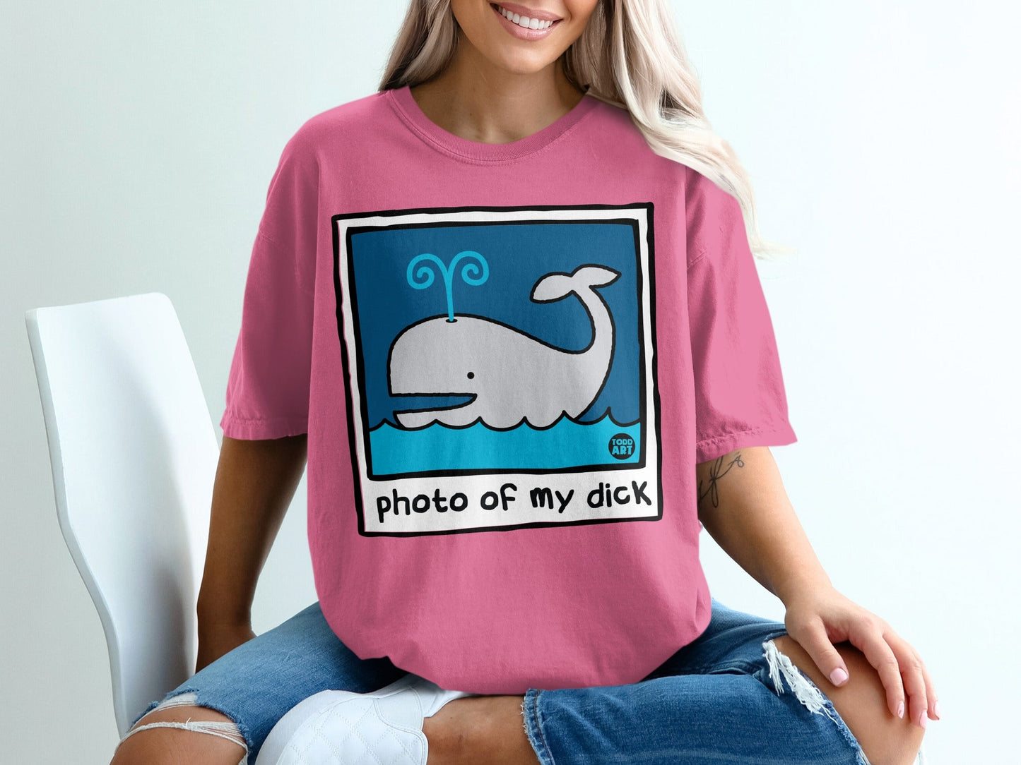 Pink t-shirt with cartoon whale and text "photo of my dick".