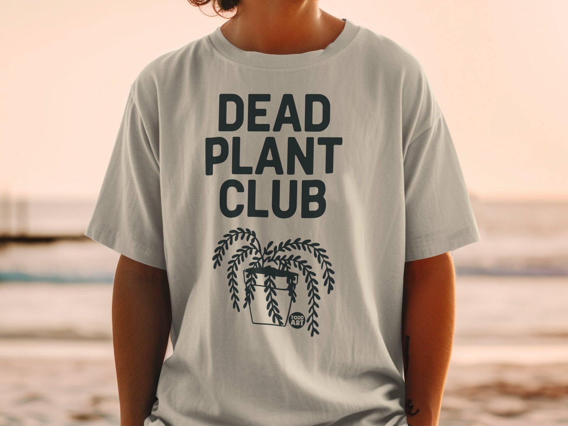 Gray t-shirt with "DEAD PLANT CLUB" and a hanging potted plant graphic.