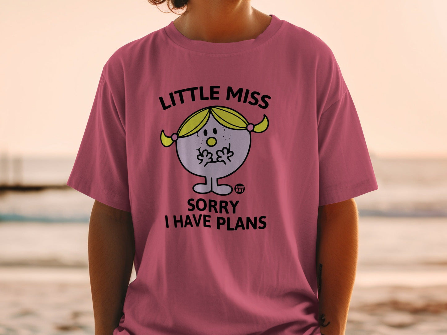 Pink t-shirt with "Little Miss Sorry I Have Plans" text and cartoon.