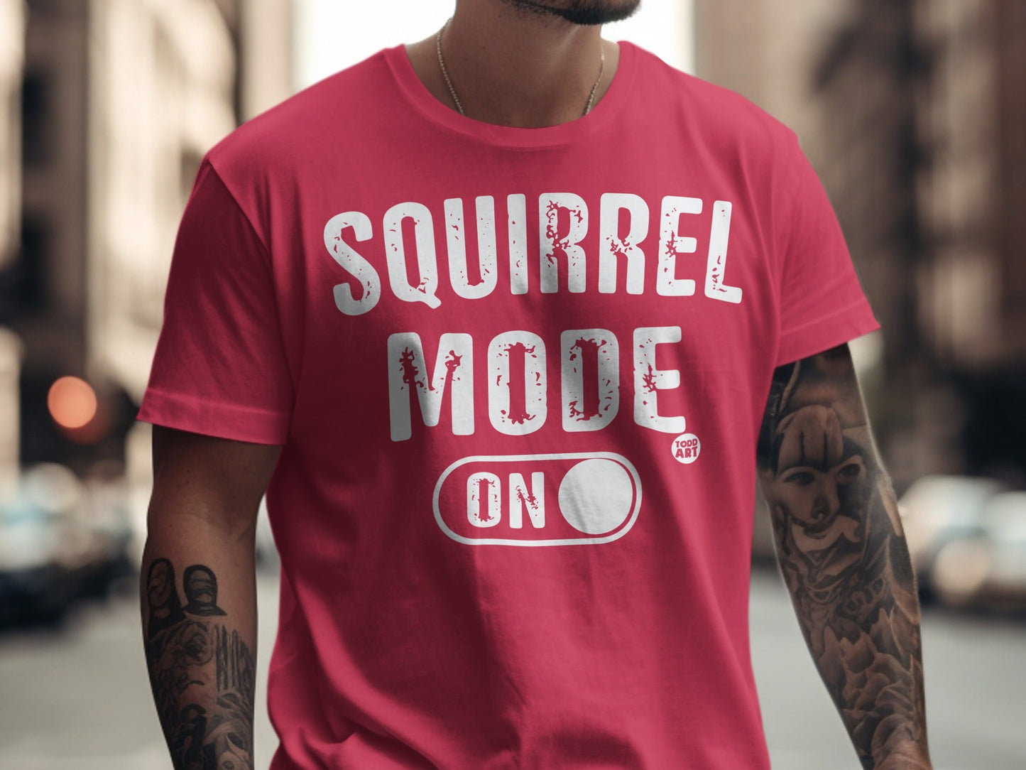 Red t-shirt with "SQUIRREL MODE ON" text and an outline of a toggle switch.