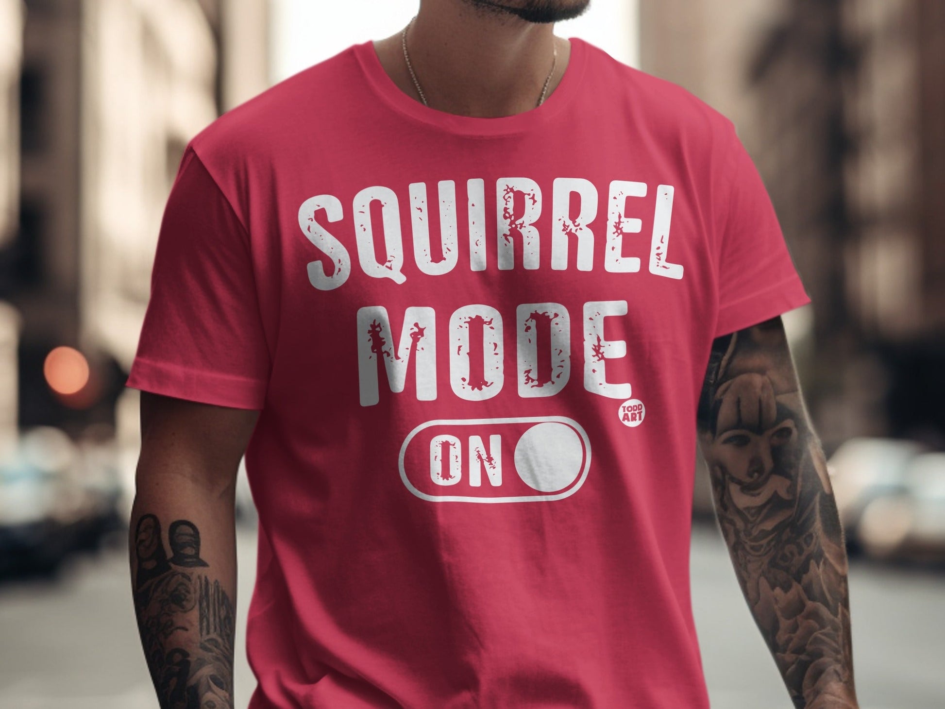 Red t-shirt with "SQUIRREL MODE ON" text and an outline of a toggle switch.