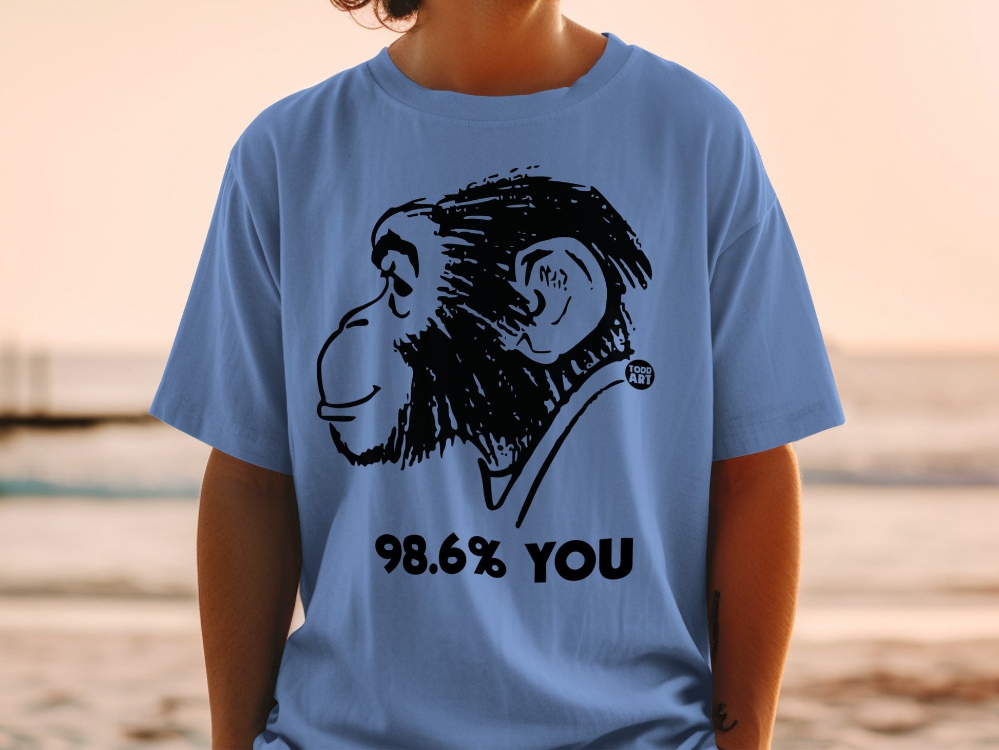 Blue t-shirt with black monkey graphic and "98.6% YOU" text.