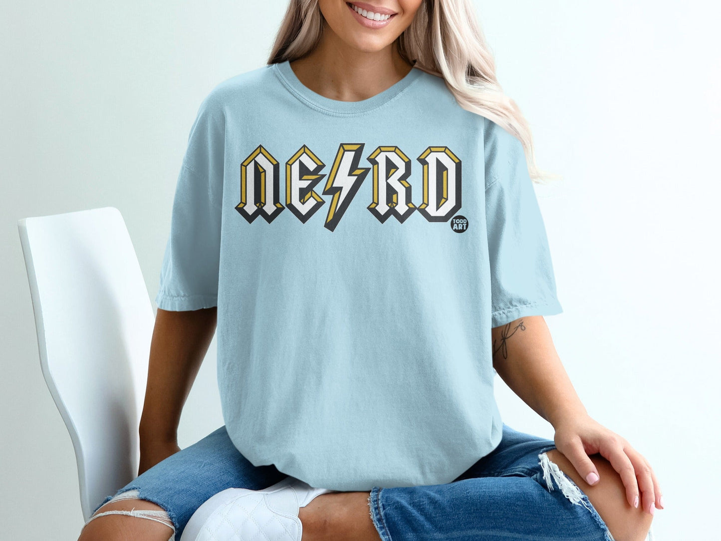 Light blue t-shirt with "NERD" and lightning bolt graphic.