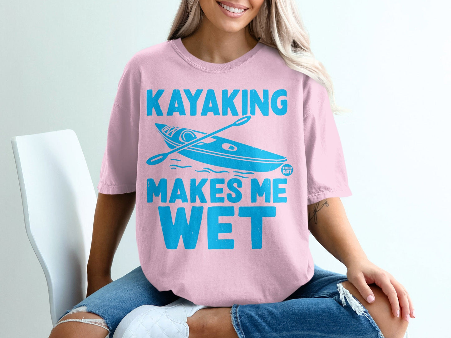 Pink t-shirt with "Kayaking Makes Me Wet" and a kayak illustration.