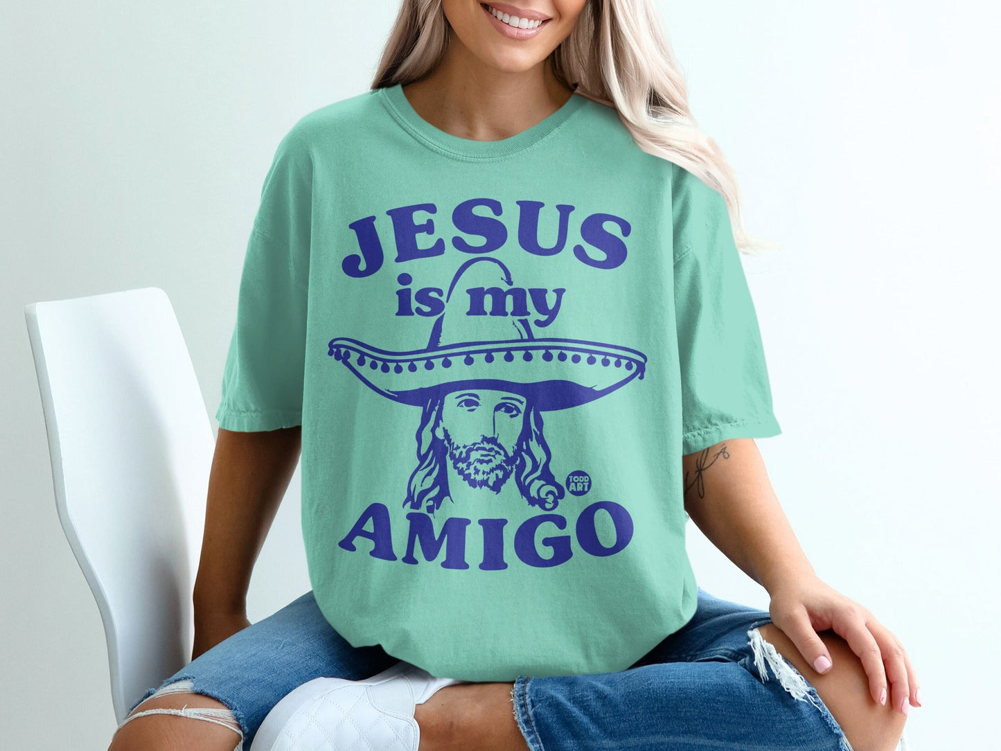 Teal t-shirt with Jesus wearing a sombrero, text "JESUS IS MY AMIGO".