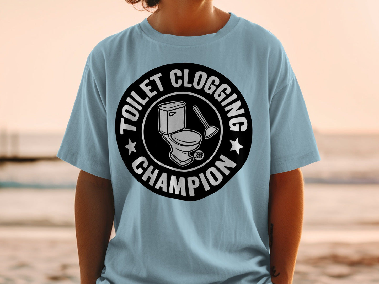 Light blue t-shirt with "Toilet Clogging Champion" and toilet graphic.