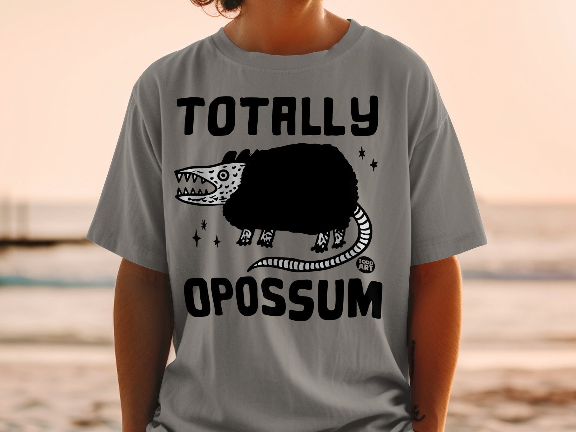 Grey t-shirt with "TOTALLY OPOSSUM" and cartoon opossum graphic.