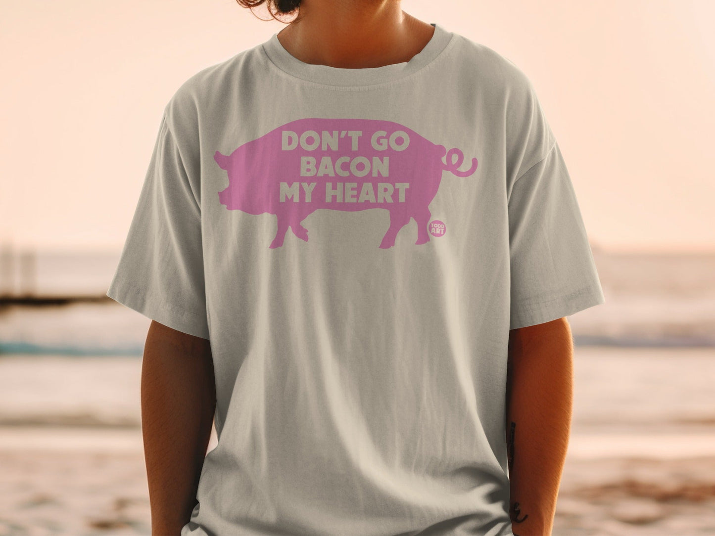 Grey t-shirt with pink pig graphic and text "Don't Go Bacon My Heart".