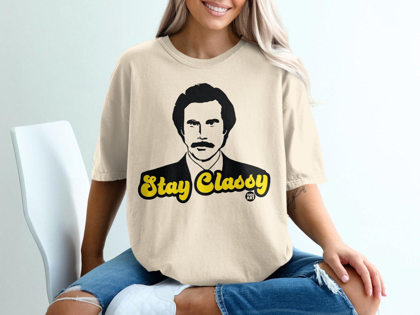 Cream t-shirt with "Stay Classy" text and Ron Burgundy's face.