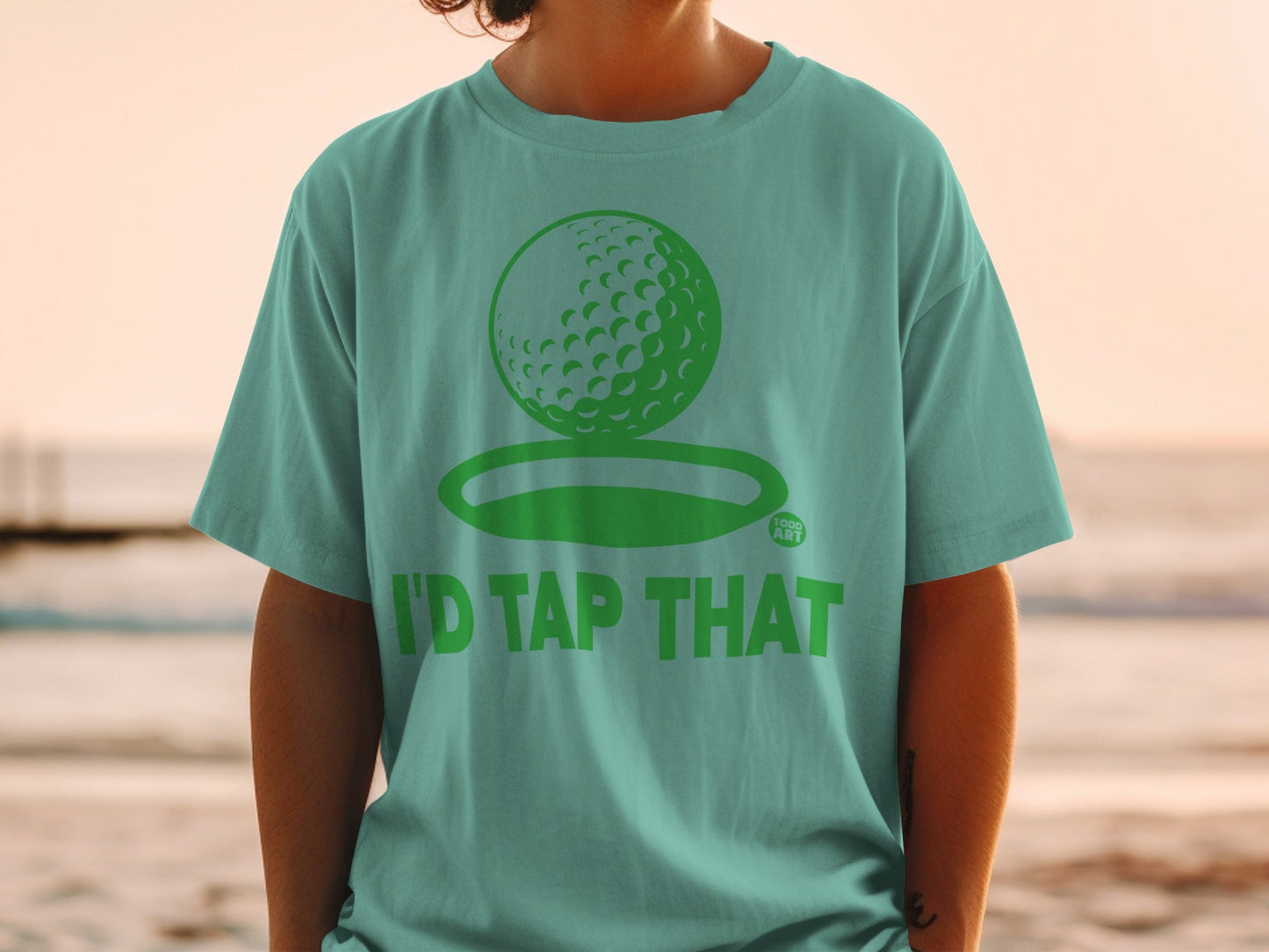 Green t-shirt with golf ball graphic and "I'D TAP THAT" text.