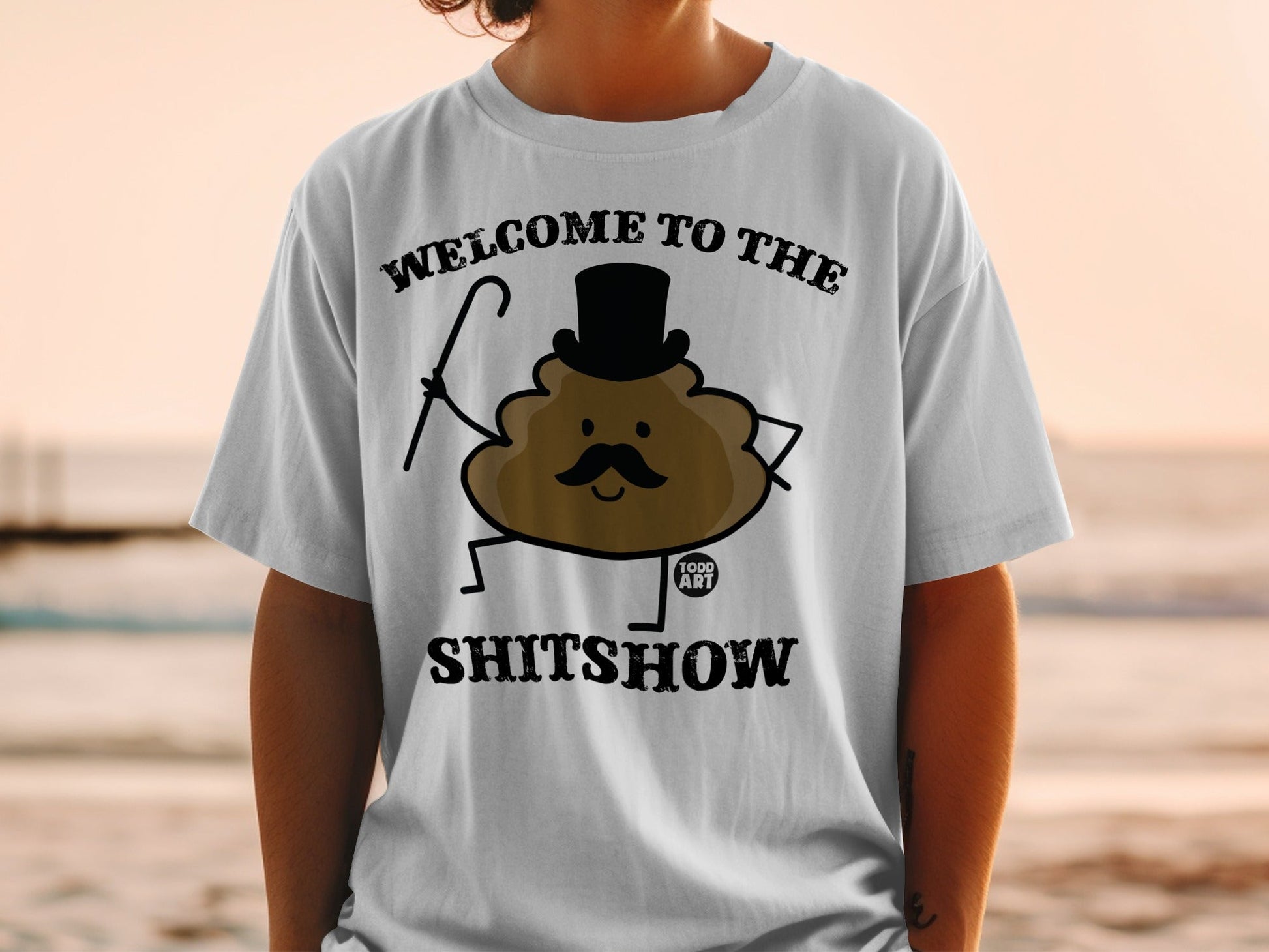 T-shirt with "Welcome to the Shitshow" text and a cartoon poop character.