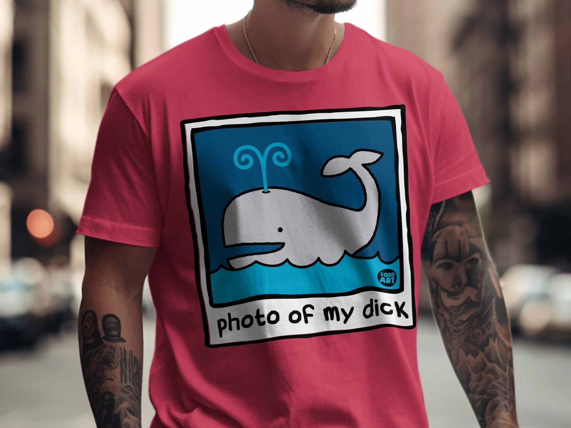 Pink t-shirt with cartoon whale and "photo of my dick" text.