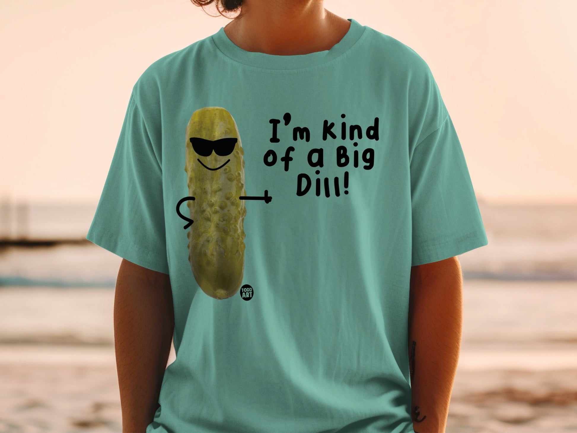 T-shirt with cartoon pickle wearing sunglasses and stating "I'm kind of a Big Dill!".