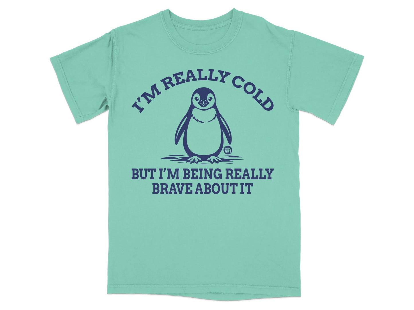 Mint green t-shirt with a penguin graphic and the text "I'm really cold but I'm being really brave about it."