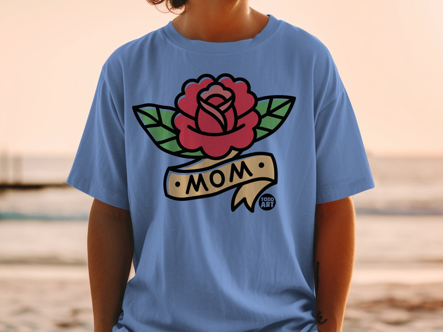 Blue t-shirt with red rose tattoo design and "MOM" banner.