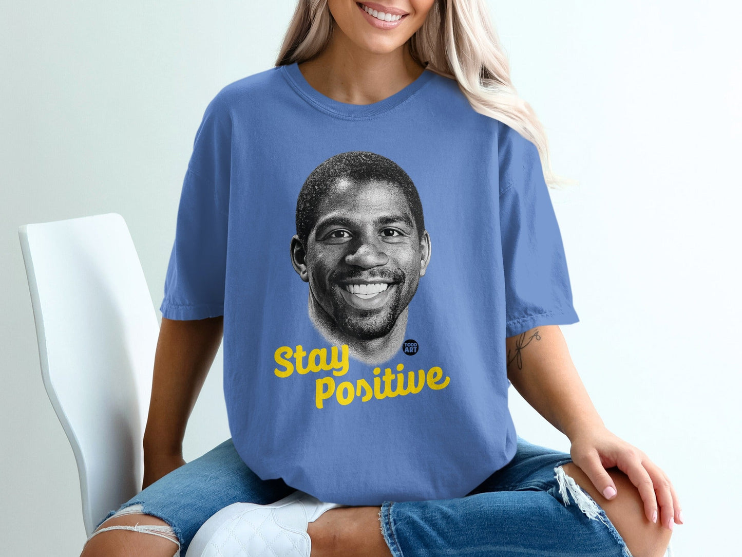 Blue t-shirt featuring Magic Johnson's portrait with "Stay Positive" text.