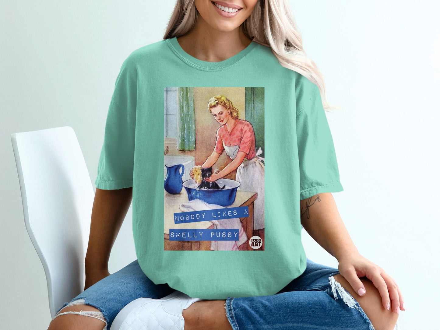 Retro graphic t-shirt with woman washing a cat in a sink.