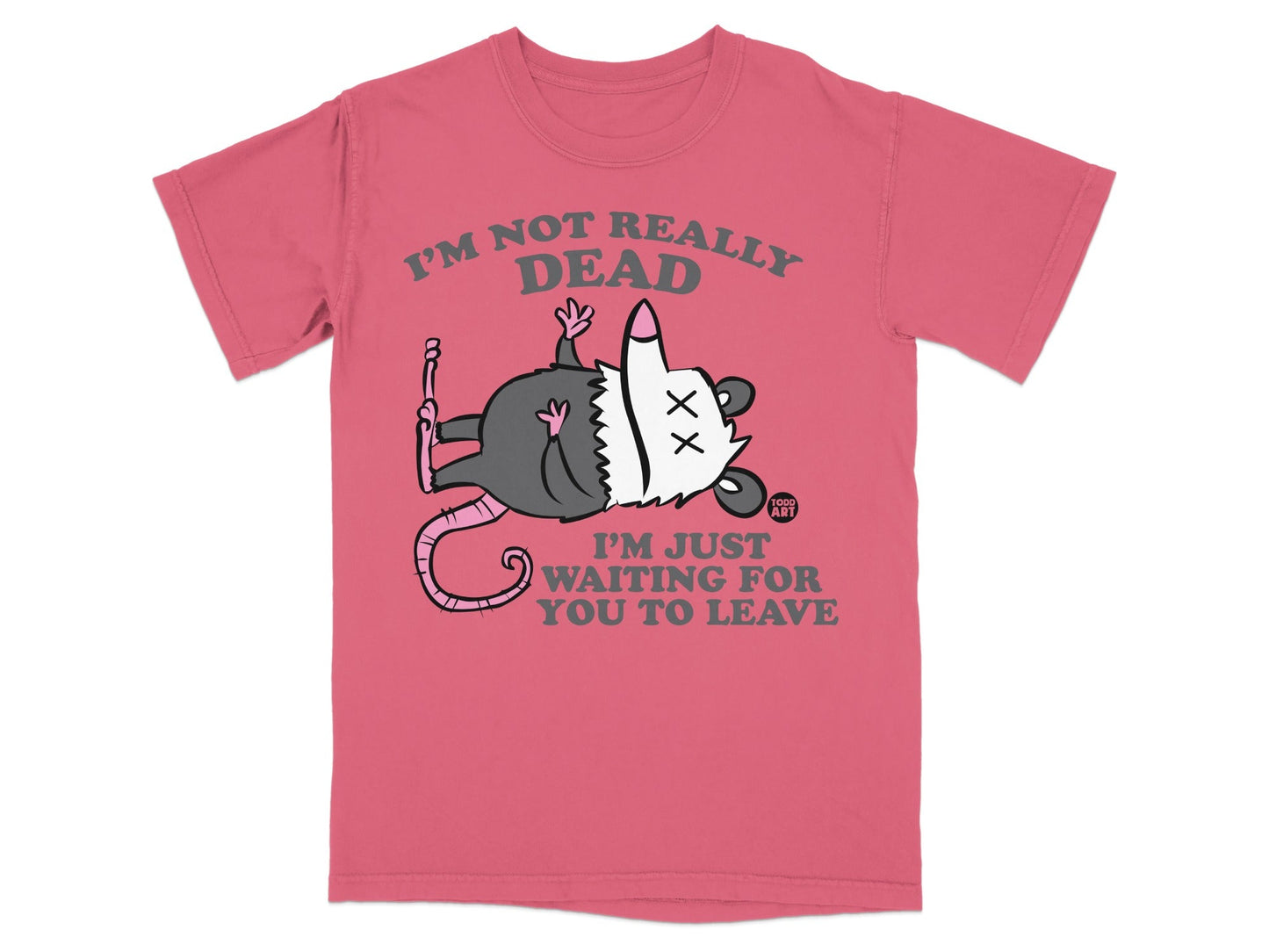 Pink t-shirt with a cartoon opossum playing dead and text "I'M NOT REALLY DEAD I'M JUST WAITING FOR YOU TO LEAVE".