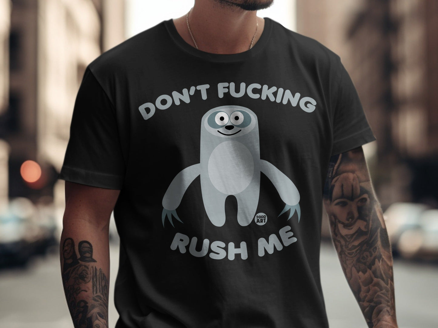 Black t-shirt with a cartoon sloth and text "DON'T FUCKING RUSH ME".