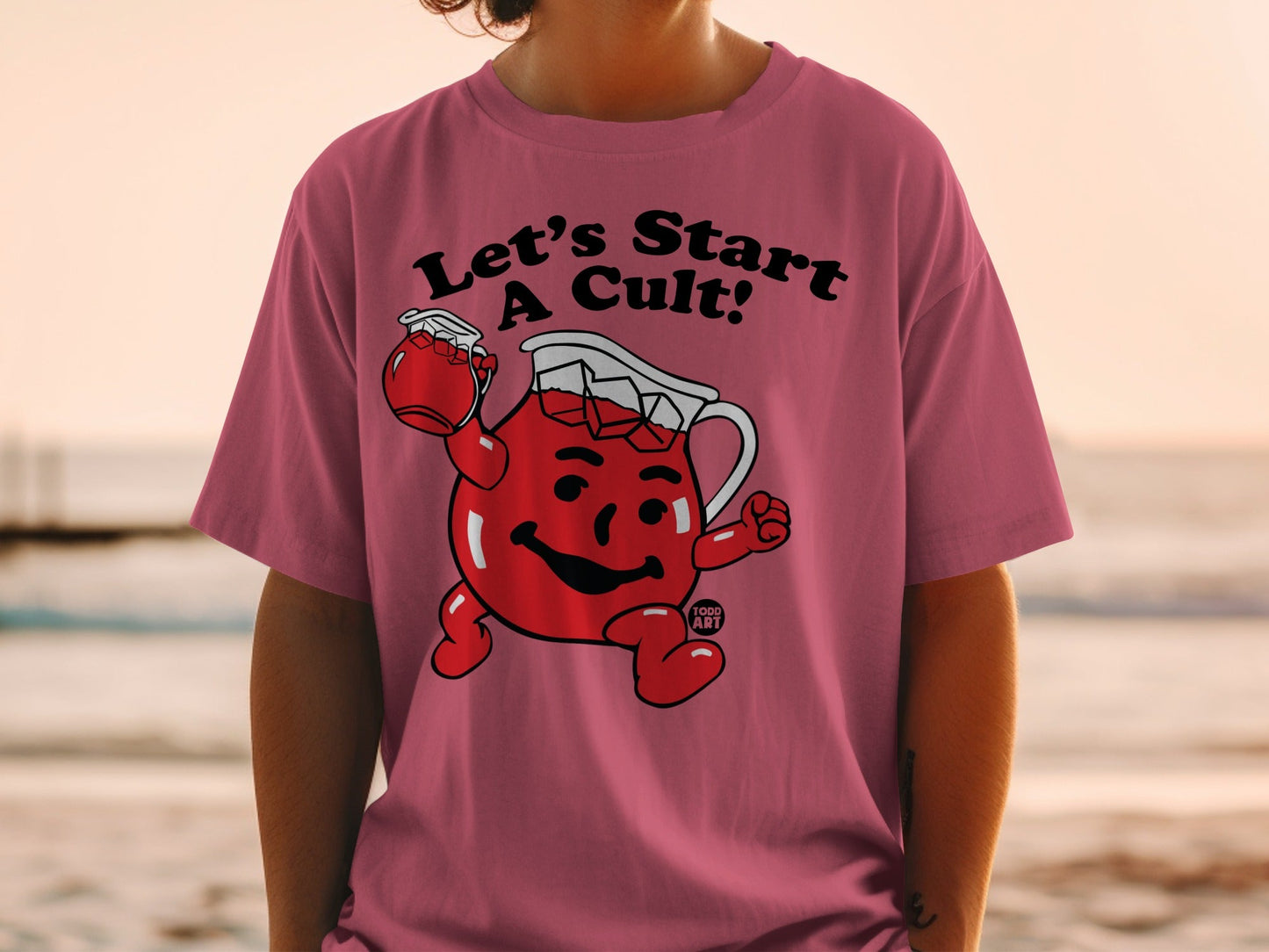Kool-Aid Man character on pink t-shirt saying "Let's Start A Cult!"